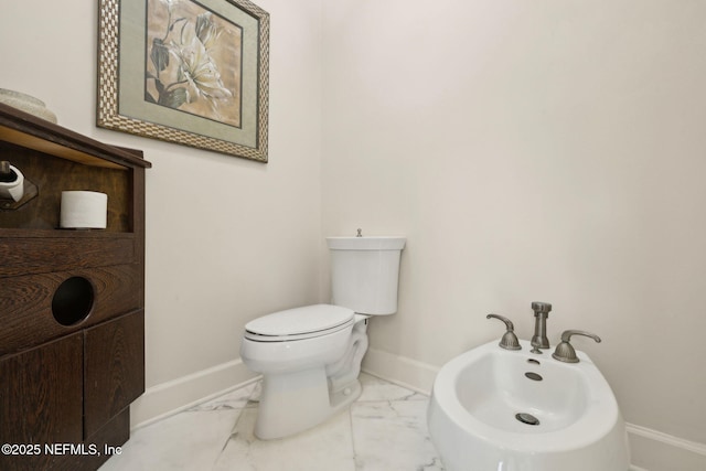 6260 Highlands Ct, Ponte Vedra Beach, FL 32082 - bathroom with baseboards, marble look tile flooring, a bidet, and toilet