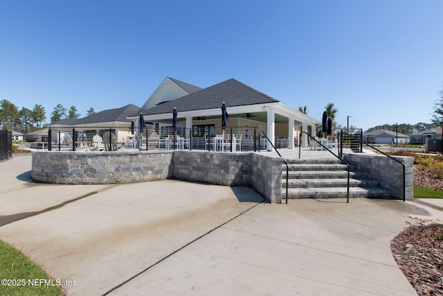 75586 Pondside Ln, Yulee, FL 32097 - view of front of home featuring a patio, a shingled roof, and fence