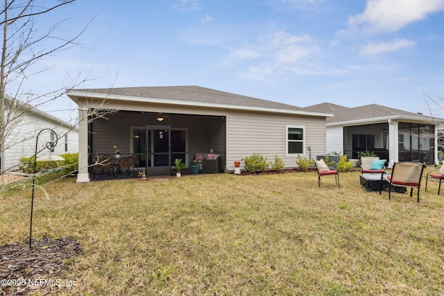 75586 Pondside Ln, Yulee, FL 32097 - rear view of house featuring a sunroom, roof with shingles, and a lawn