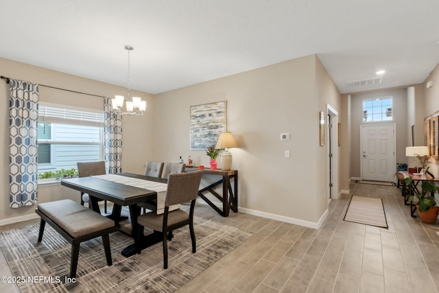 75586 Pondside Ln, Yulee, FL 32097 - dining area with light wood finished floors, baseboards, a notable chandelier, and visible vents