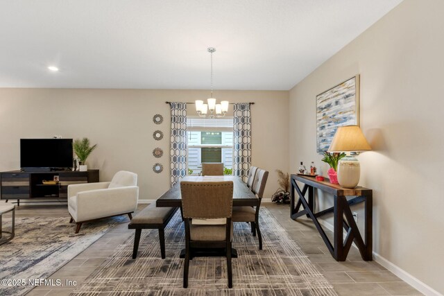 75586 Pondside Ln, Yulee, FL 32097 - dining room featuring an inviting chandelier, wood finish floors, and baseboards