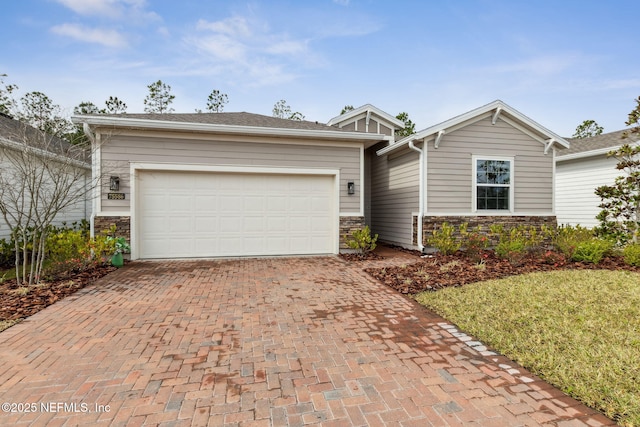 75586 Pondside Ln, Yulee, FL 32097 - ranch-style home with stone siding, decorative driveway, and a garage