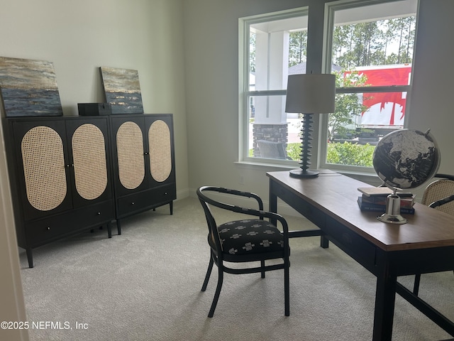 carpeted office space featuring baseboards