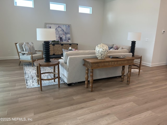 living area with baseboards and light wood-style floors