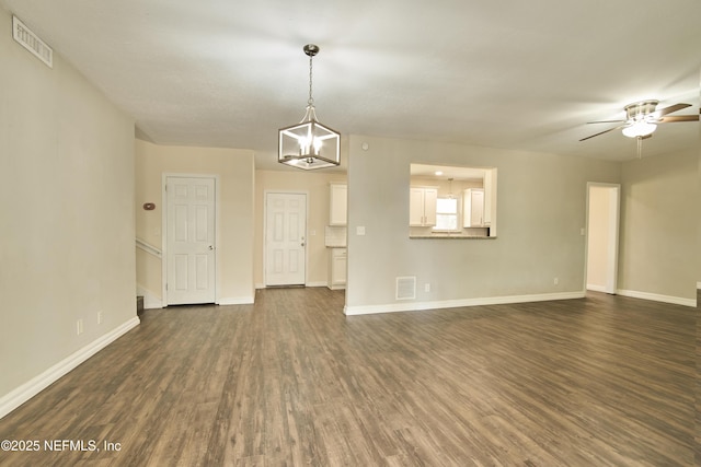 10568 Lake View Rd E, Jacksonville, FL 32225 - unfurnished living room featuring dark wood-style floors, visible vents, baseboards, and ceiling fan with notable chandelier