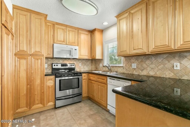 3434 Blanding Blvd Unit 201, Jacksonville, FL 32210 - kitchen with backsplash, a sink, light tile patterned floors, light brown cabinets, and white appliances