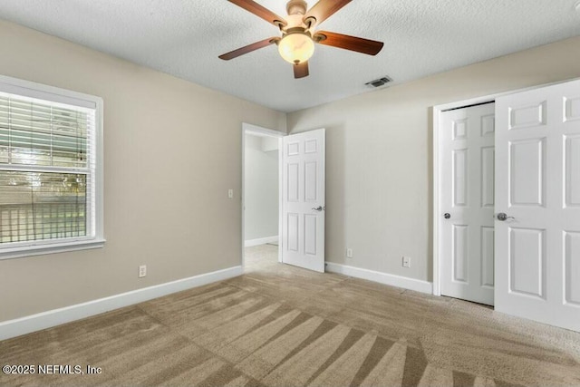 3434 Blanding Blvd Unit 201, Jacksonville, FL 32210 - unfurnished bedroom featuring baseboards, carpet flooring, and a textured ceiling