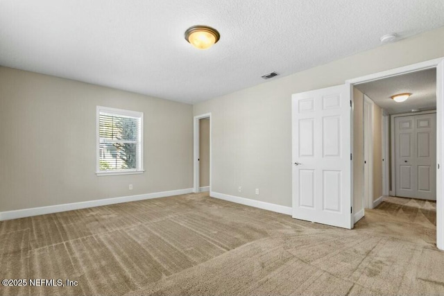 3434 Blanding Blvd Unit 201, Jacksonville, FL 32210 - empty room featuring carpet flooring, a textured ceiling, baseboards, and visible vents