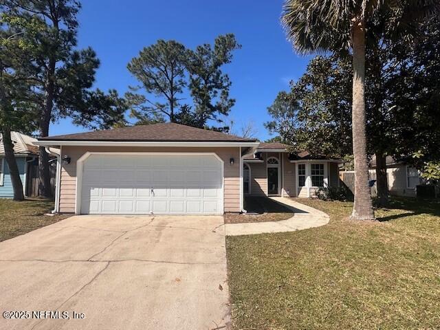 3387 Guernsey Ct, Jacksonville, FL 32226 - ranch-style home featuring a garage, a front lawn, and concrete driveway