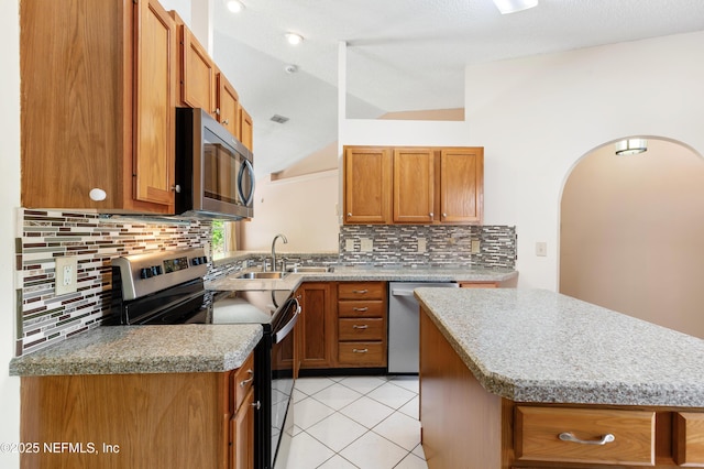 3387 Guernsey Ct, Jacksonville, FL 32226 - kitchen featuring decorative backsplash, vaulted ceiling, a sink, and appliances with stainless steel finishes