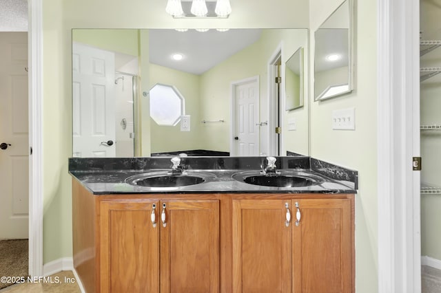 3387 Guernsey Ct, Jacksonville, FL 32226 - bathroom with a spacious closet, a sink, a shower stall, and double vanity