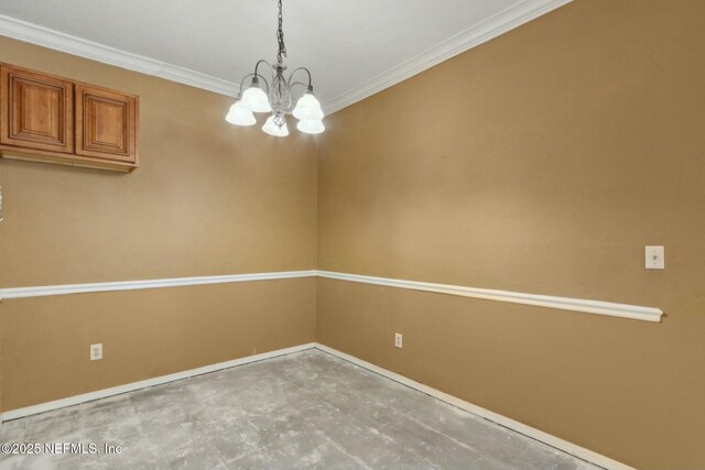 spare room with ornamental molding, concrete floors, a notable chandelier, and baseboards