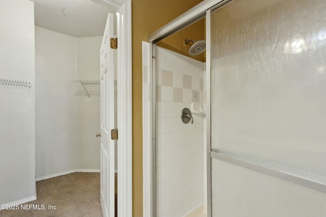 full bath with baseboards and a shower stall