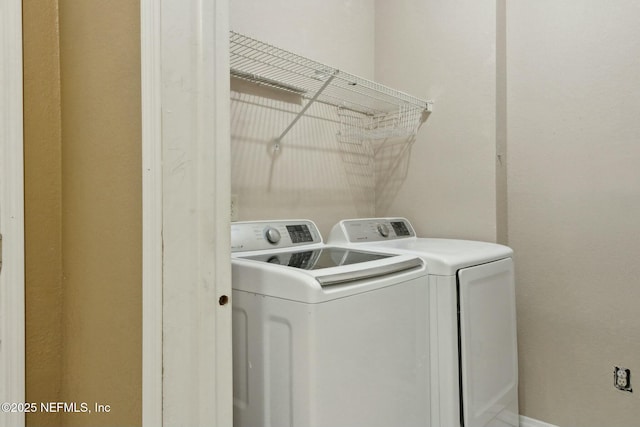clothes washing area with laundry area and washer and dryer