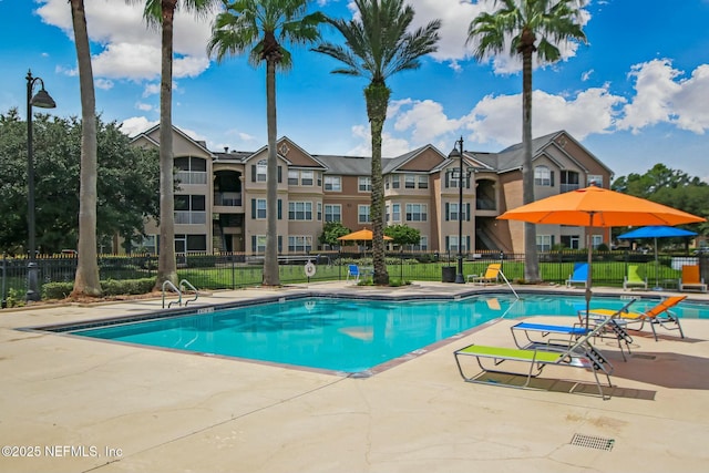 pool featuring fence and a patio