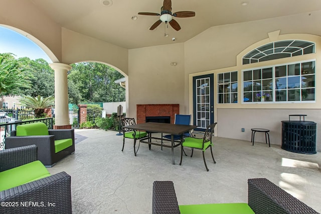 view of patio featuring outdoor lounge area, ceiling fan, outdoor dining area, and fence