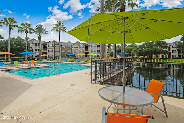 pool featuring fence and a patio