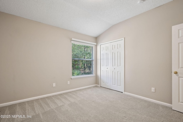 745 Austin Pl, Saint Johns, FL 32259 - unfurnished bedroom with carpet floors, a textured ceiling, a closet, baseboards, and lofted ceiling