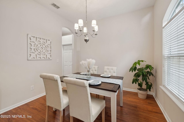 745 Austin Pl, Saint Johns, FL 32259 - dining area featuring a chandelier, arched walkways, wood finished floors, and baseboards