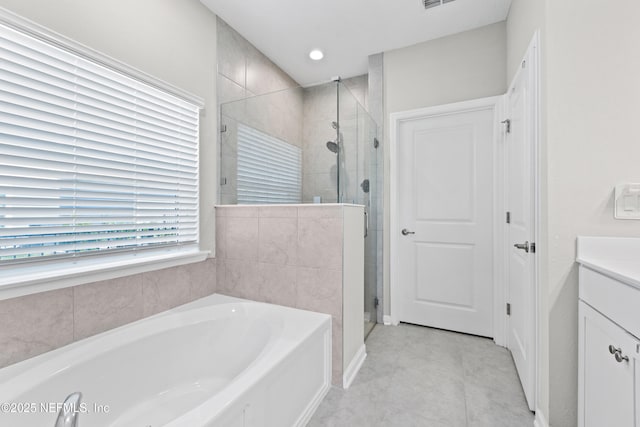 full bath with vanity, a shower stall, a bath, baseboards, and visible vents