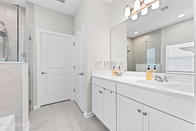 bathroom featuring tile patterned floors, a sink, a stall shower, visible vents, and double vanity
