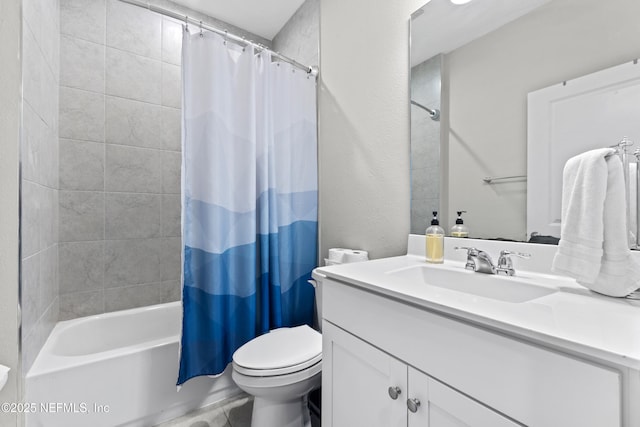 full bathroom featuring a textured wall, toilet, shower / tub combo with curtain, and vanity