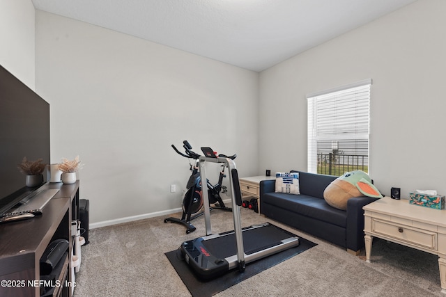 exercise room with carpet flooring and baseboards