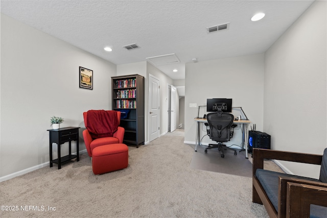 office area featuring baseboards, visible vents, carpet, and a textured ceiling