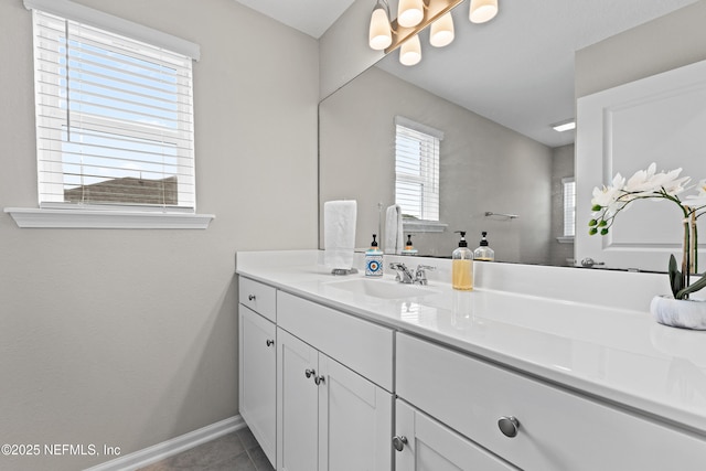 bathroom featuring baseboards, tile patterned flooring, and vanity