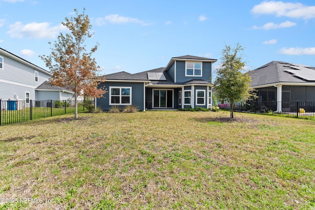 back of property featuring a fenced backyard and a lawn