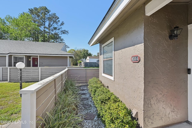 8314 Derbyshire Pl, Jacksonville, FL 32244 - view of property exterior with stucco siding and fence