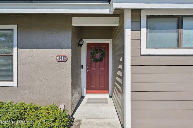 8314 Derbyshire Pl, Jacksonville, FL 32244 - doorway to property with stucco siding