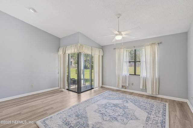 8314 Derbyshire Pl, Jacksonville, FL 32244 - spare room with a ceiling fan, a healthy amount of sunlight, vaulted ceiling, and wood finished floors