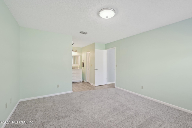 8314 Derbyshire Pl, Jacksonville, FL 32244 - unfurnished bedroom with baseboards, a textured ceiling, visible vents, and light colored carpet