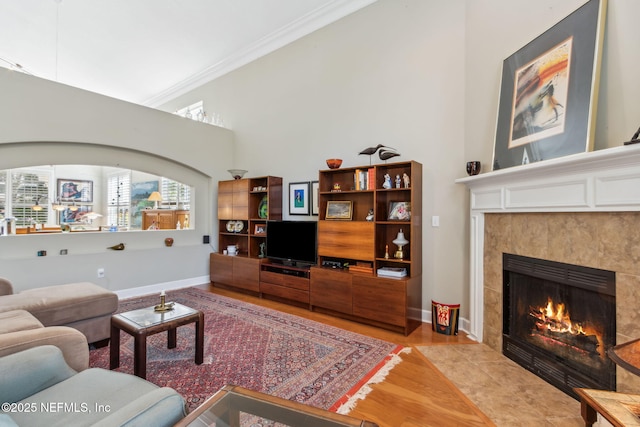 95062 Mackinas Cir, Fernandina Beach, FL 32034 - living area with baseboards, light tile patterned floors, a tile fireplace, and crown molding