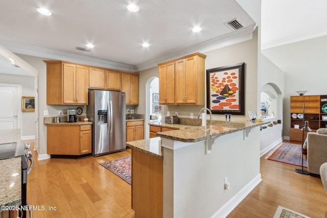 95062 Mackinas Cir, Fernandina Beach, FL 32034 - kitchen with light wood-style flooring, visible vents, arched walkways, and stainless steel appliances
