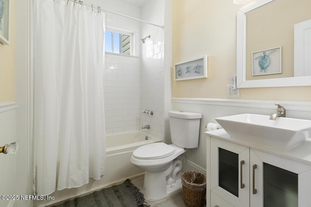 29 Grant St, Saint Augustine, FL 32084 - full bathroom featuring wainscoting, shower / tub combo, toilet, and vanity