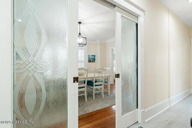 29 Grant St, Saint Augustine, FL 32084 - hallway with wood finished floors, baseboards, and ornamental molding