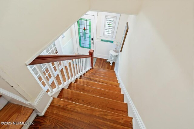 29 Grant St, Saint Augustine, FL 32084 - stairway featuring wood finished floors and baseboards