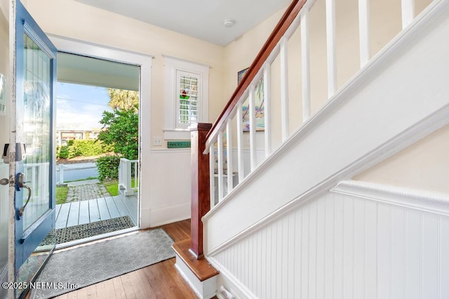 29 Grant St, Saint Augustine, FL 32084 - foyer entrance with a wainscoted wall, stairway, wood finished floors, and a decorative wall