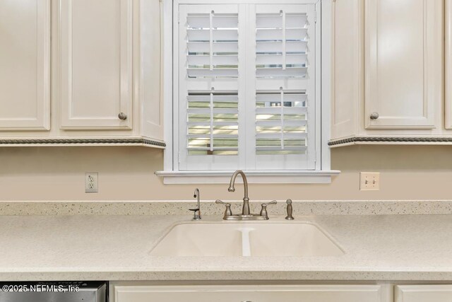 29 Grant St, Saint Augustine, FL 32084 - kitchen with a sink, white cabinets, light stone countertops, and stainless steel dishwasher