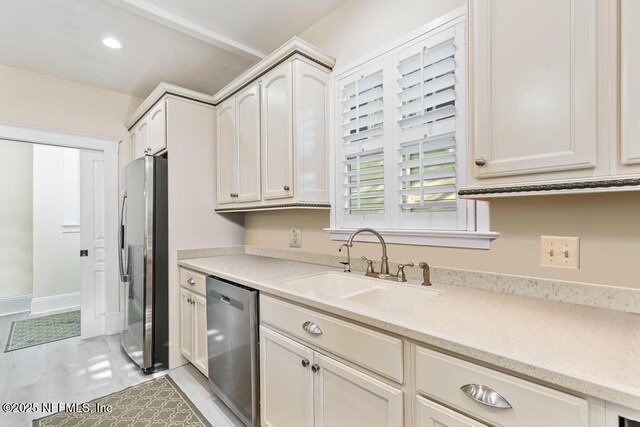 29 Grant St, Saint Augustine, FL 32084 - kitchen featuring stainless steel appliances, a sink, recessed lighting, light stone counters, and light tile patterned floors