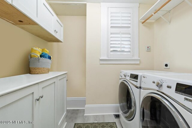 29 Grant St, Saint Augustine, FL 32084 - laundry room featuring cabinet space, separate washer and dryer, baseboards, and light wood finished floors