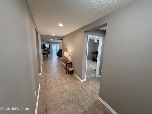 3118 Steeple Pine Ct, Middleburg, FL 32068 - hall featuring light tile patterned floors, a textured ceiling, baseboards, and recessed lighting