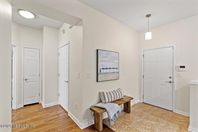 entrance foyer featuring baseboards and light wood-style flooring
