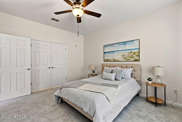 bedroom featuring visible vents, a closet, carpet flooring, and a ceiling fan