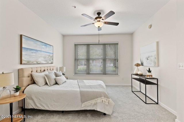carpeted bedroom with a ceiling fan and baseboards