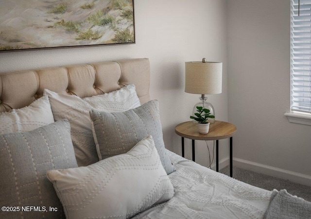 carpeted bedroom featuring baseboards