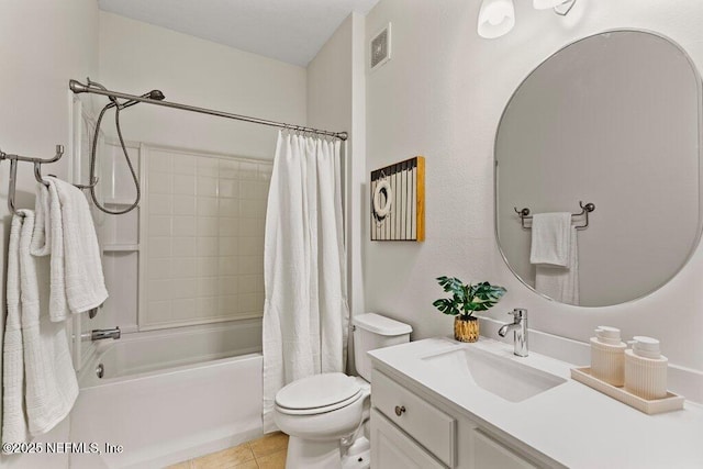 full bathroom featuring tile patterned floors, toilet, vanity, shower / bath combo with shower curtain, and visible vents