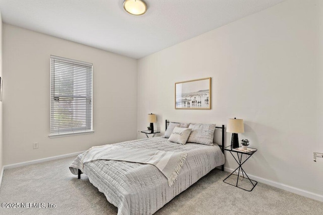 bedroom with baseboards and carpet